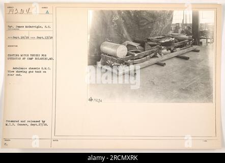 PROCESS A photograph captured on September 13, 1918, at Camp Holabird, MD, shows Sgt. James McGarrigle, S.C., crating motor trucks for overseas deployment during World War I. The image depicts an ambulance chassis of G.M.C., with a gas tank located at the rear end. This photograph was censored and released by M.I.D. Censor on September 27, 1918. Stock Photo