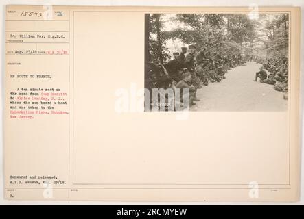 Lieutenant William Fox, from the Signal Corps, captures a moment during World War I. The photograph shows soldiers resting for 10 minutes on the road from Camp Merritt to Alpine Landing in New Jersey. These soldiers are en route to France and will eventually board a boat at Embarkation Piers in Hoboken. The photograph was censored and released by the M.I.B. censor on August 23, 1918. This information is provided by the description attached to the image, which has the identification number 111-SC-15592. Stock Photo