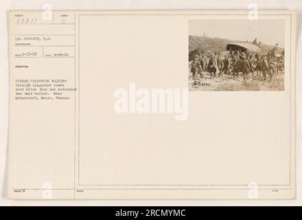 German prisoners of war being escorted by American soldiers through congested roads in Malancourt, Meuse, France. The prisoners had retreated two days before the photograph was taken on September 28, 1918. (Photographed by Lt. Jackson, S.C., on February 13, 1919, and recorded as image number 38311 in the collection.) Stock Photo