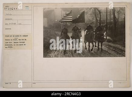 Caption: 'Image shows the 5th Field Artillery (1st Division) passing through Hetzerath on their way to the Rhine. This photograph, taken during World War I, captures the vibrant colors of the troops as they advance towards Germany.' Stock Photo