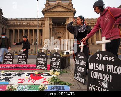 Lima, Peru. 15th July, 2023. Tombstones with the names of those killed in the protests are displayed on the street when dozens gather to protest in front of the judiciary in a vigil as a prelude to the great national march called for next July 19th against President Dina Boluarte and the Congress.In previous riots, between December and March of this year, there were more than 50 deaths due to the use of excessive force by the police to control the protesters. Credit: Fotoholica Press Agency/Alamy Live News Stock Photo