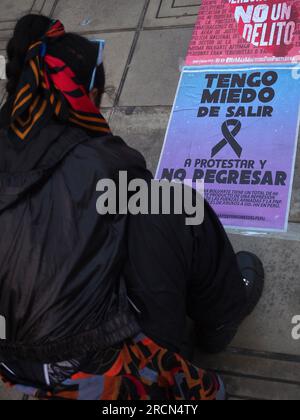 Lima, Peru. 15th July, 2023. 'I'm afraid of going out to protest and not coming back' can be read on a poster when dozens gather to protest in front of the judiciary in a vigil as a prelude to the great national march called for next July 19th against President Dina Boluarte and the Congress.In previous riots, between December and March of this year, there were more than 50 deaths due to the use of excessive force by the police to control the protesters. Credit: Fotoholica Press Agency/Alamy Live News Stock Photo