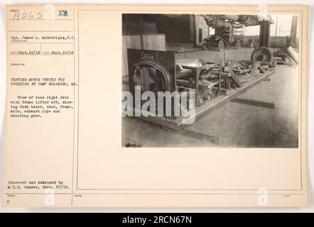 Caption: 'Sgt. James L. McGarrigle and a group of soldiers seen crating motor trucks for overseas shipment at Camp Holabird, MD during World War One. This specific image shows the rear right side of a truck, with frame lifted off, revealing the dash board, seat, frame, axle, exhaust pipe, and steering gear. Photo censored and released by M.I.D. Censor on September 27, 1918.' Stock Photo