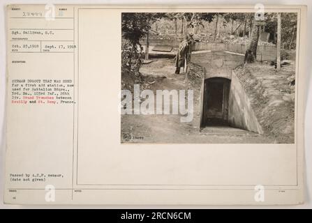 A soldier stands next to a destroyed German dugout that was once a first aid station but is now being used as Battalion Headquarters. The dugout is located in the Grand Trenches between Neuilly and St. Remy, France. This photograph was taken on September 17, 1918 by Sgt. Gallivan. Stock Photo