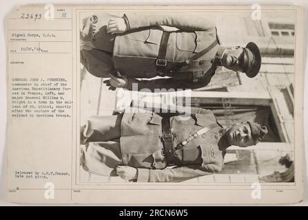 General John J. Pershing, the commander in chief of the American Expeditionary Forces in France, is seen standing on the left of the image. Major General William M. Wright is standing next to him. The photograph was taken in a town in the salient of St. Mihiel shortly after its capture by American troops. It is part of the collection released by A.E.P. Censor. Stock Photo