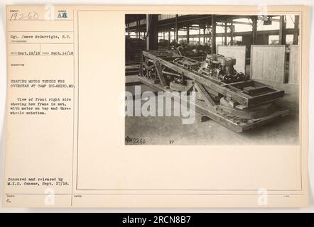 Sgt. James McGarrigle is seen crating motor trucks for overseas deployment at Camp Holabird, MD. The photograph shows the front right side of the truck, with the frame set, motor on top, and three wheels at the bottom. This image was censored and released by the M.I.D. Censor on September 27, 1918. Stock Photo