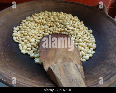 roasting peanuts without oil on the stove with earthenware or ceramic from clay Stock Photo
