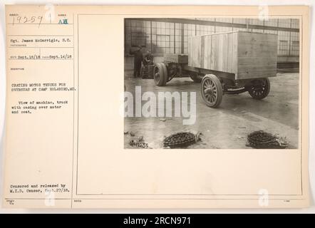 Sgt. James McGarrigle is seen crating motor trucks for overseas deployment at Camp Holabird, Maryland. The image shows a view of a truck with a casing over its motor and seat. The photograph was taken on September 14, 1918, and censored and released by the M.I.D. Censor on September 27, 1918. Stock Photo