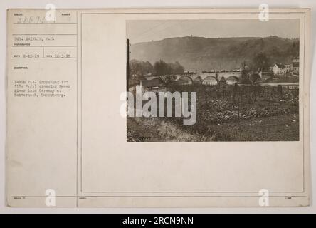 American soldiers from the 149th Field Artillery, formerly known as the 1st Illinois Field Artillery, can be seen crossing the Sauer River into Germany at Echternach, Luxembourg. The photograph was taken on December 3, 1918, by Sergeant Hainlin, an army photographer. The soldiers are equipped with blue issued notes. Stock Photo