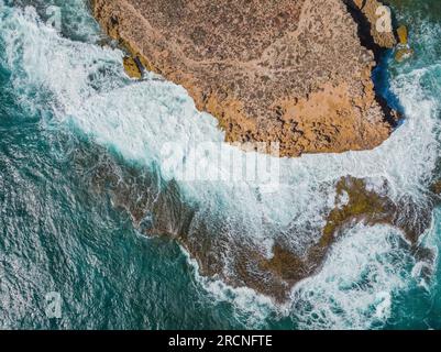 Aerial view of large waves breaking on a rugged eroded coastline at Venus Bay on the Eyre Peninsula in South Australia Stock Photo