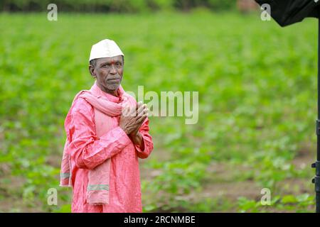 Indian happy farm worker , working in farm Stock Photo