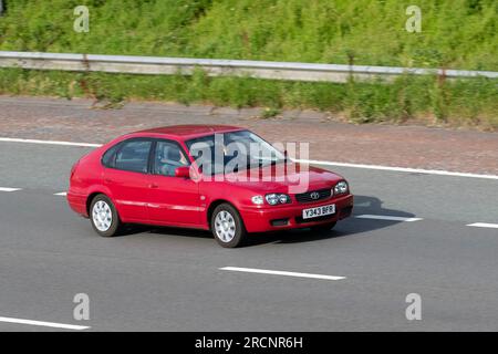 2001 Red Toyota Corolla Vvti Gs VVT-I Hatchback Petrol car 1398 cc; travelling at speed on the M6 motorway in Greater Manchester, UK Stock Photo