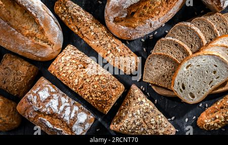 Assorted bakery products including loafs of bread and rolls Stock Photo