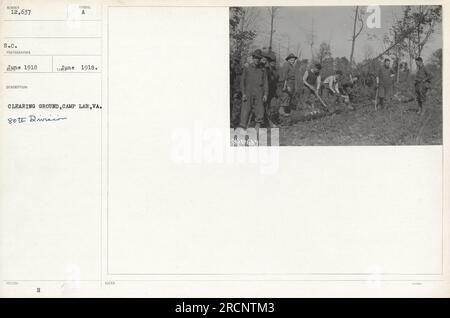 Soldiers from the 80th Division gather and rest at a clearing ground in Camp Lee, Virginia in June 1918. This location served as a resting and organizing point for troops during World War I. Stock Photo