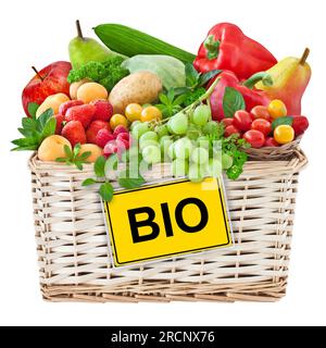 Various fresh fruits and vegetables in a basket with bio label isolated on white background Stock Photo