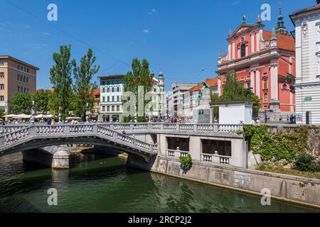 City of Ljubljana in Slovenia, Triple Bridge over Ljubljanica River and Franciscan Church of the Annunciation at Preseren Square. Stock Photo