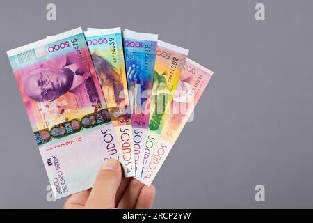 Cape Verdean money - escudo in the hand on a gray background Stock Photo