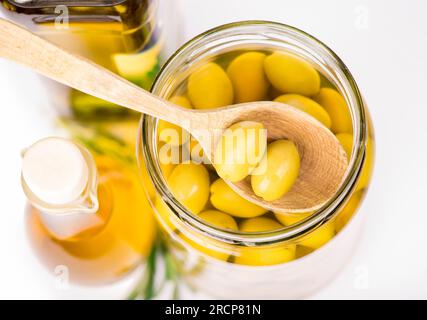 Close up green olives in bank isolated on the white Stock Photo