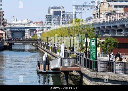 Tokyo, Japan-April 2023; View over a canal in the Sumida ward from Koume bridge towards Genmori Bridge leading to the Sumida river lined with bars and Stock Photo