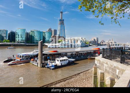 London, United Kingdom - May 5, 2011 : Tower Millennium Pier, HMS Belfast, and The Shard Tower being built. Landmarks on River Thames. Stock Photo