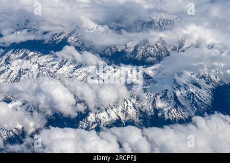 Aerial view at 38,000 feet of snow covered mountain tops around Birch County, Alberta, Canada at 55 41.1542N 118 32.675W Stock Photo