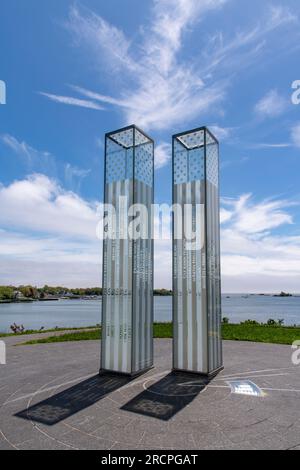 Greenwich, CT, USA-May 2022;  Low angle view of two glass towers of the September 11 Memorial in Cos Cob Memorial Park throwing shadow on ground again Stock Photo