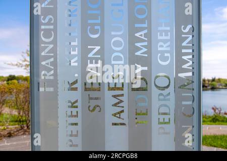 Greenwich, CT, USA-May 2022;  Close up view of engraved names in glass tower of the September 11 Memorial in Cos Cob Memorial Park with letters of nam Stock Photo