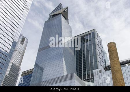 New York City, NY, USA-June 2022; Vertical view of traditional brick industrial building in Chelsea neighborhood with large chimney or smokestack in f Stock Photo