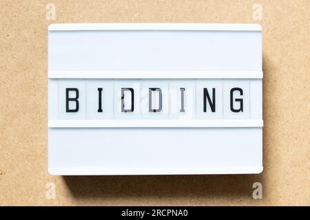 Lightbox with word bidding on wood background Stock Photo