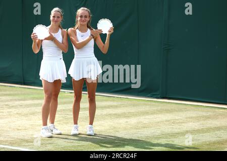 Hannah Klugman (left) and Isabelle Lacy with the runners up trophies following the Girls' Doubles Final match against Alena Kovackova and Laura Samsonova on day fourteen of the 2023 Wimbledon Championships at the All England Lawn Tennis and Croquet Club in Wimbledon. Picture date: Sunday July 16, 2023. Stock Photo