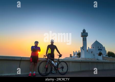 Two male cyclist Silhouette in Khobar Corniche . City: Khobar, country : Saudi Arabia.Photo taken month of December 22nd Year 2019. Stock Photo