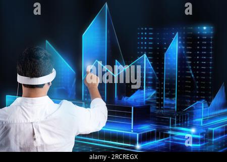 Touch to future. Businessman in vision pro vr headset touching glowing virtual holographic image, black background Stock Photo