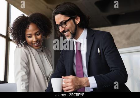 Cheerful international team of professionals working on project together Stock Photo