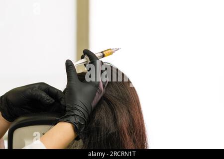 Esthetician uses thin needle to inject Platelet-Rich Plasma in skin ...