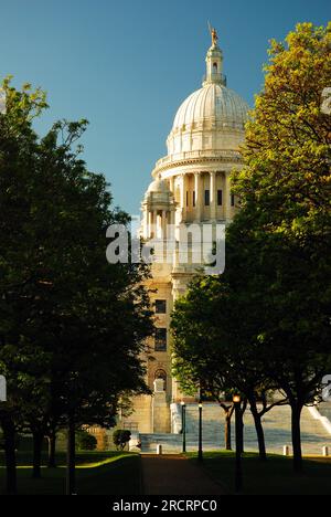The dome of the Rhode Island State Capitol in Providence pokes through an opening in the trees Stock Photo