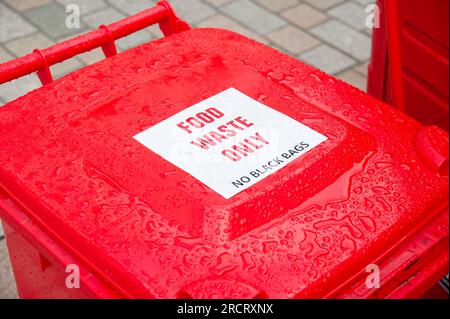 Food waste only and no black bags sign on red bin Stock Photo