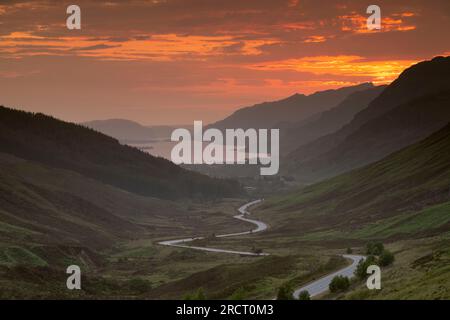 The Sun Setting Behind the Mountains on Letterewe Estate Seen from Glen Docherty Late in the Evening in Summer Stock Photo