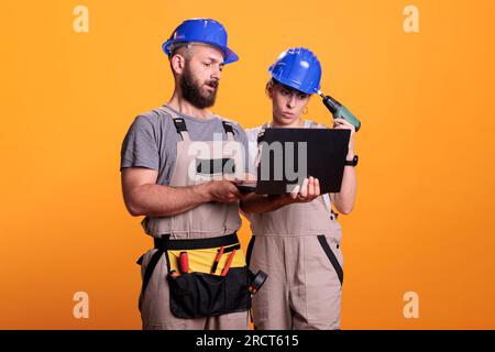 Craftsman looking at blueprint in studio Stock Photo - Alamy