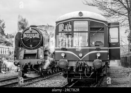 Class 101/111 waits with BR '9F' 2-10-0 No. 92214 at Loughborough, Great Central Railway, Leicestershire Stock Photo