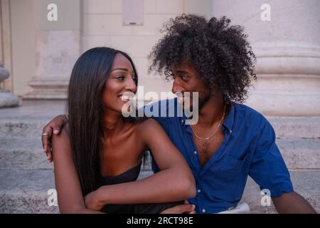 A couple spends a moment of passion together, African lovers talk and look at each other. Stock Photo