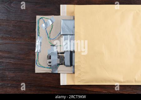 Mail bomb. Improvised Explosive Device with plastic explosive C-4 and cell phone GSM module in envelope Stock Photo