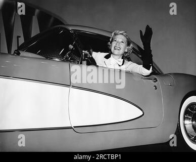 New York, New York:   January, 1956 Dinah Shore waves from the driver's seat of a 1956 Corvette at the General Motors Motorama Show. Chevrolet was the sponser of her TV show. Stock Photo