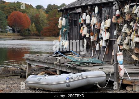 low tide with boat on sand at Cape Neddick Lobster Pound, York, Me and a wall of buoys October 23 2021 Stock Photo