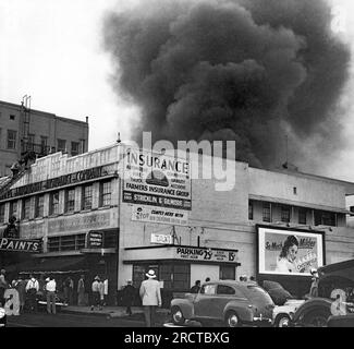 California:  1950 A Farmers Insurance Building on fire with a huge cloud of smoke coming out of the roof. Stock Photo
