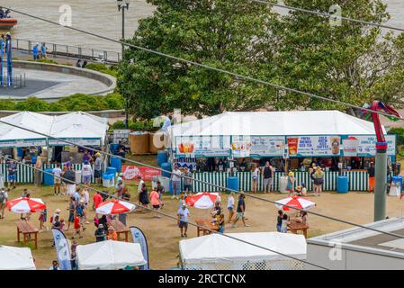 NEW ORLEANS, LA, USA - APRIL 24, 2022: Aerial view of food and drink booths (with patrons) along the Mississippi River for the French Quarter Festival Stock Photo
