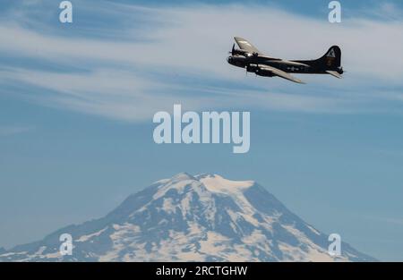 A Boeing B-17 Flying Fortress flies over the McChord Field flightline