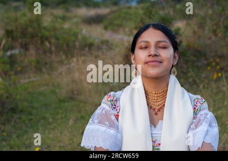 copyspace of beautiful young indian woman doing yoga and performing spiritual exercises in nature Stock Photo