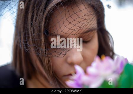 Close-up of a grieving young woman wearing a mourning veil (symbol image, model released) Stock Photo