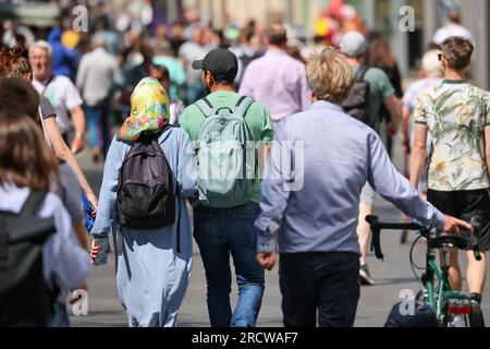 Leipzig, Germany. 27th June, 2023. A woman wearing a headscarf and her companion are walking through the city center. Credit: Jan Woitas/dpa/Alamy Live News Stock Photo