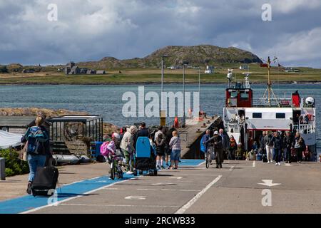 Ferry passengers queuing for the foot-ferry to Iona from Fionnphort, Isle of Mull. Stock Photo